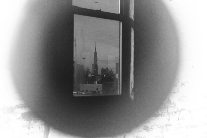Print of a skyline seen through a window, vignetted
