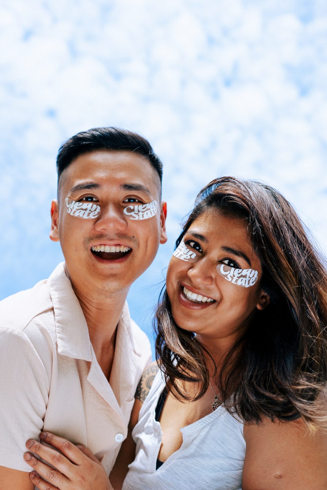 Couple mid-laugh wearing under-eye masks