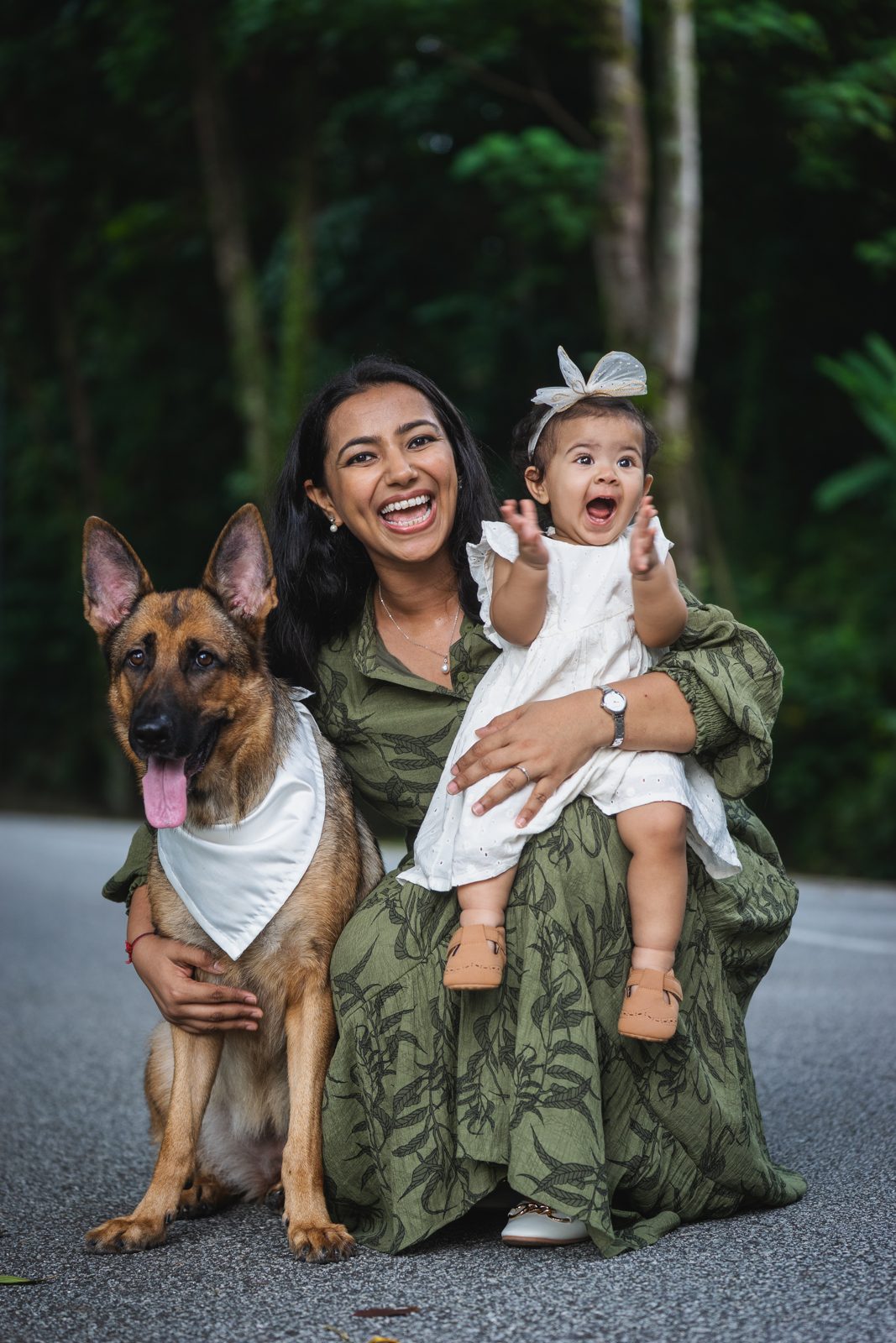 Woman with her baby and dog in the garden