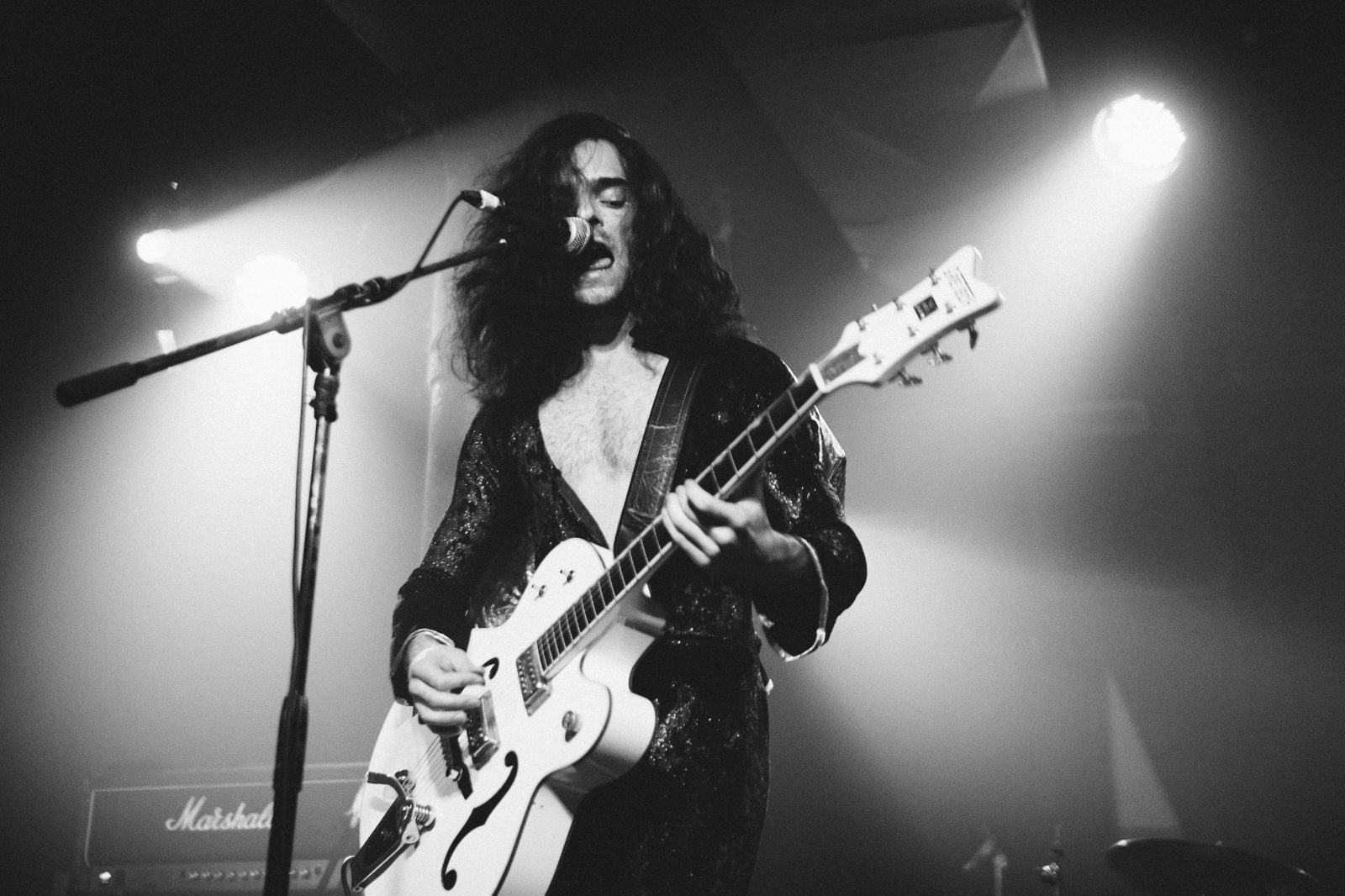 Guitarist on stage, in black and white